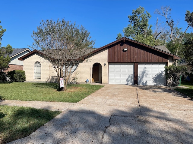 ranch-style home featuring a front yard and a garage