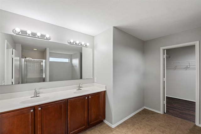 bathroom featuring walk in shower and vanity