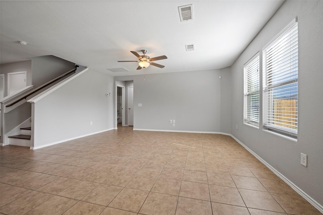 interior space with ceiling fan and light tile patterned floors