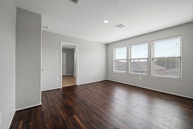 spare room featuring dark hardwood / wood-style floors