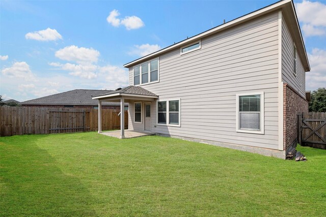 back of property featuring a yard and a patio