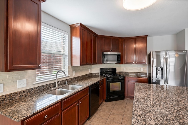 kitchen featuring decorative backsplash, sink, dark stone countertops, and black appliances