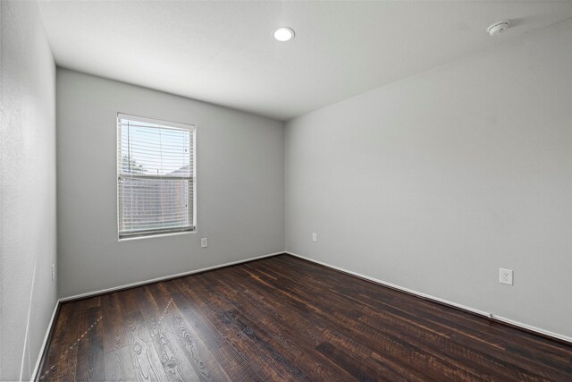 unfurnished room featuring dark hardwood / wood-style flooring