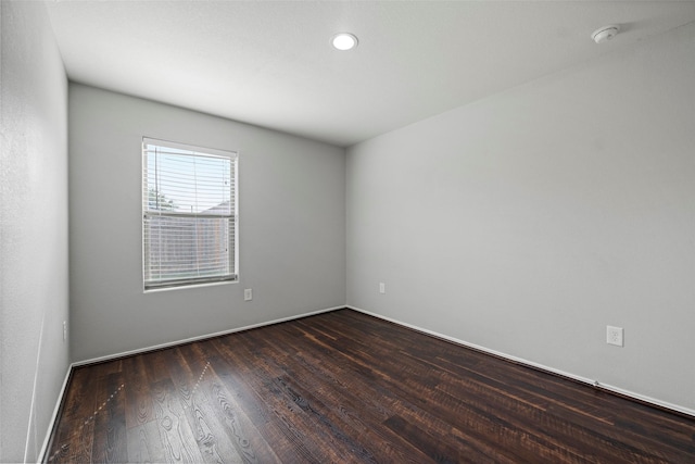 spare room with dark wood-style floors