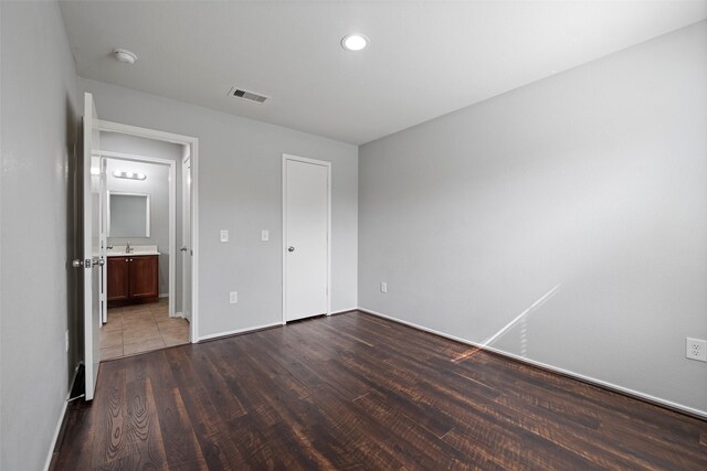 unfurnished bedroom featuring dark hardwood / wood-style flooring