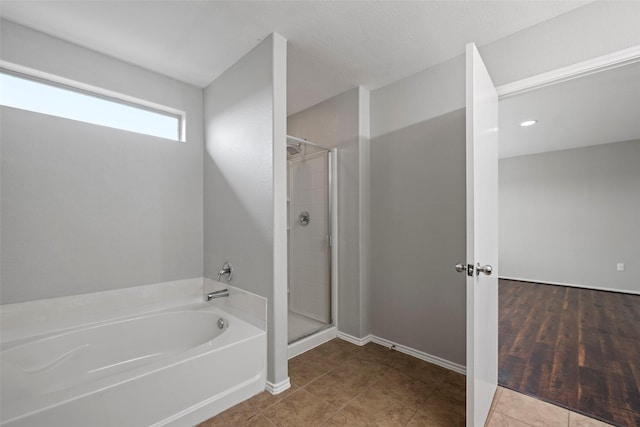 bathroom featuring tile patterned floors and plus walk in shower