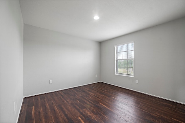 spare room featuring dark hardwood / wood-style flooring