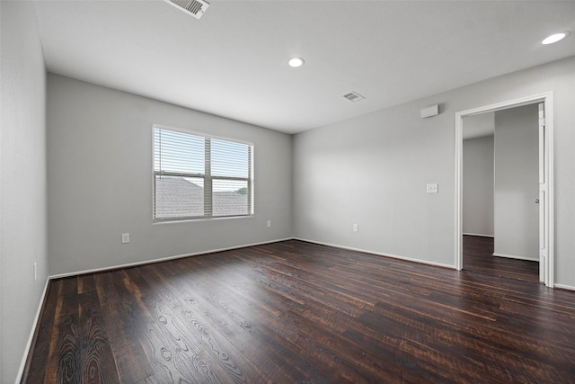 unfurnished room featuring dark wood finished floors, visible vents, and recessed lighting