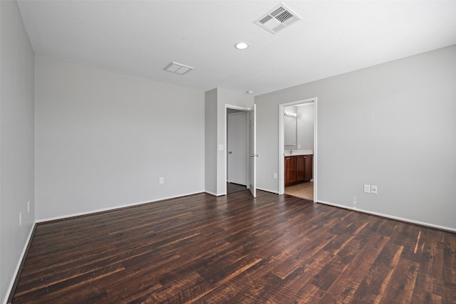 unfurnished bedroom with connected bathroom, recessed lighting, dark wood-style flooring, visible vents, and baseboards