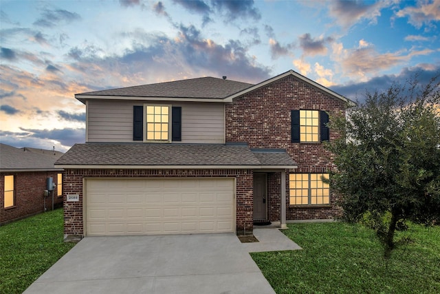 traditional-style home featuring concrete driveway, brick siding, and a front lawn