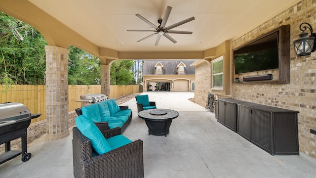 view of patio / terrace with area for grilling, ceiling fan, and an outdoor fire pit