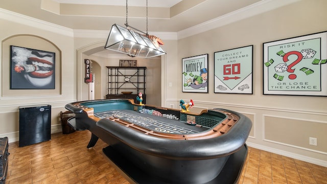 rec room with wood-type flooring and ornamental molding