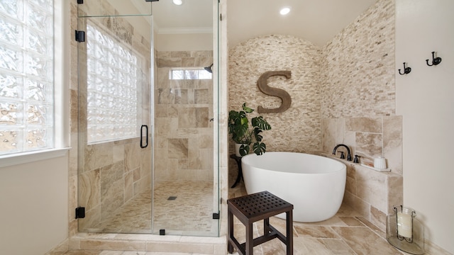 bathroom with separate shower and tub and ornamental molding