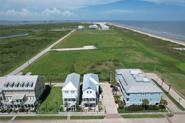 drone / aerial view featuring a water view and a beach view