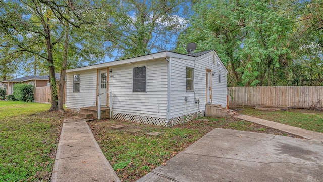 view of front of property featuring a front lawn and a patio area