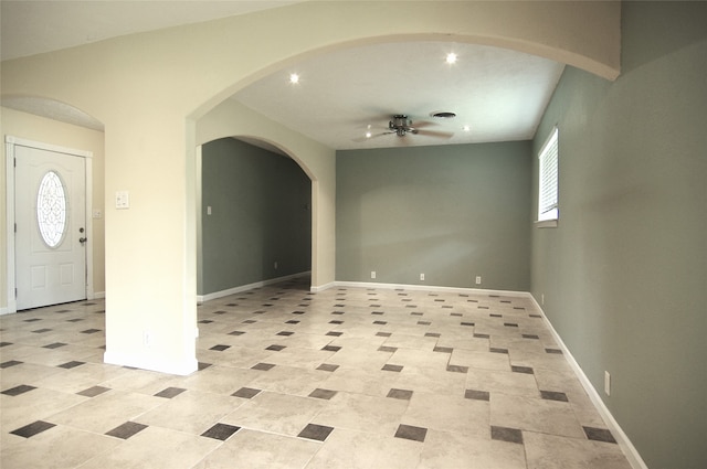 tiled entryway featuring ceiling fan