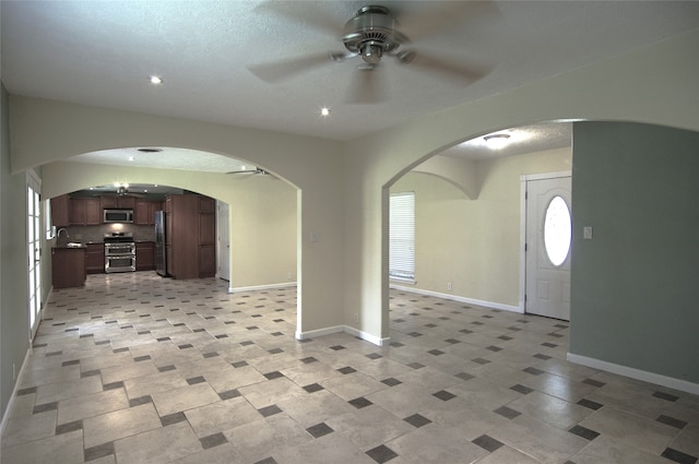 entryway with ceiling fan and sink