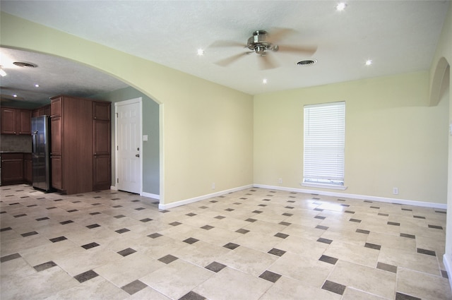 interior space with ceiling fan and a textured ceiling