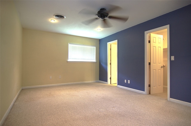 unfurnished bedroom with ceiling fan and light colored carpet