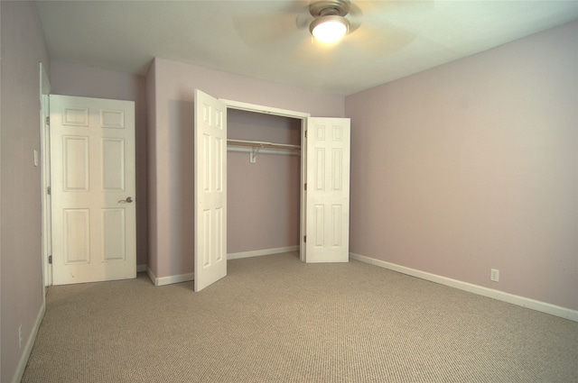 unfurnished bedroom with a closet, light colored carpet, and ceiling fan