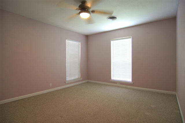 unfurnished room with carpet flooring and ceiling fan