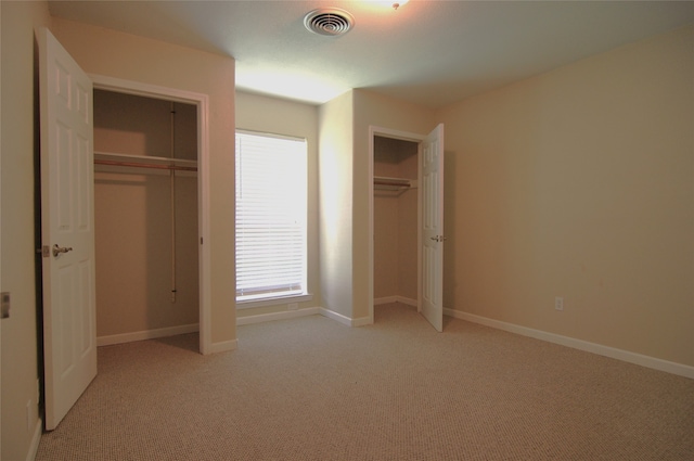 unfurnished bedroom featuring light colored carpet