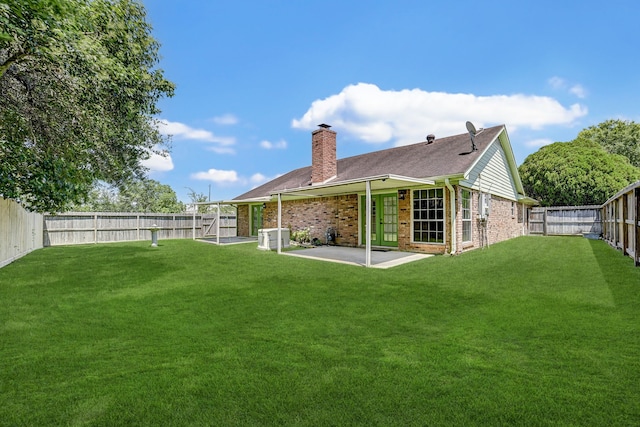 rear view of house featuring a patio area and a yard