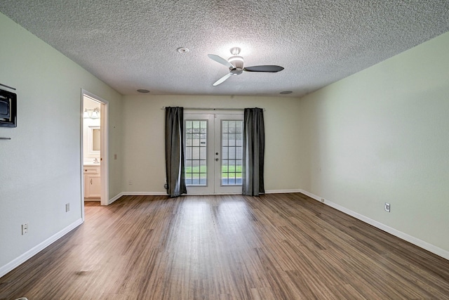 spare room with french doors, ceiling fan, hardwood / wood-style flooring, and a textured ceiling