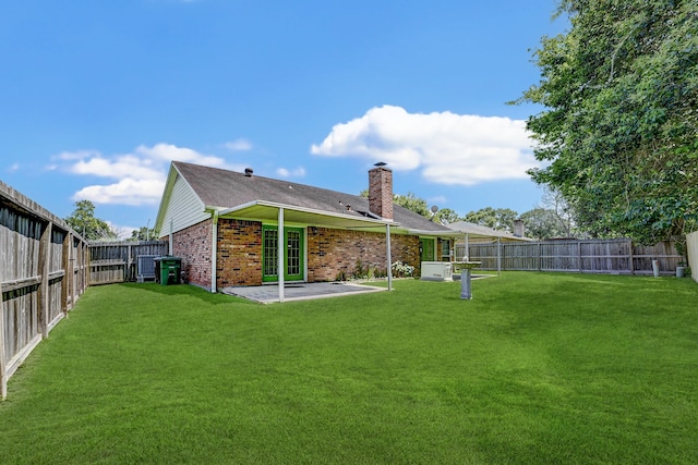 rear view of property featuring a patio and a yard