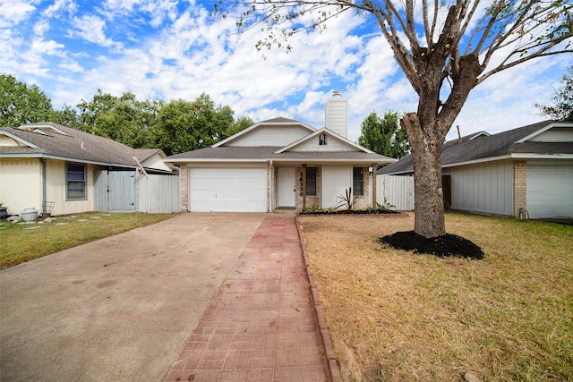 ranch-style house featuring a front yard and a garage