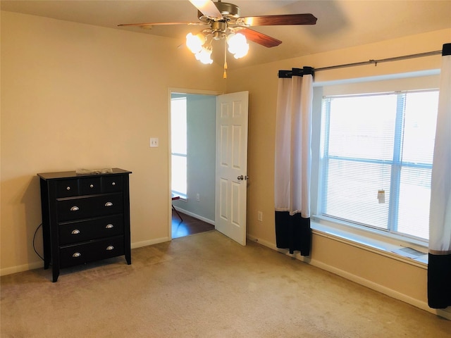 unfurnished bedroom with light carpet and ceiling fan