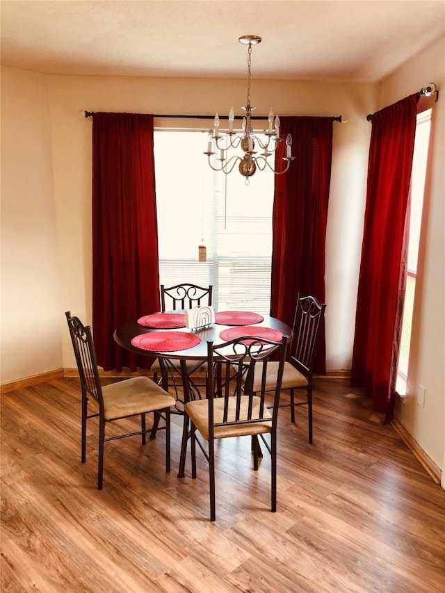 dining area featuring a chandelier and hardwood / wood-style floors