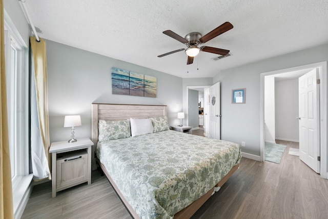 bedroom featuring a textured ceiling, hardwood / wood-style flooring, and ceiling fan