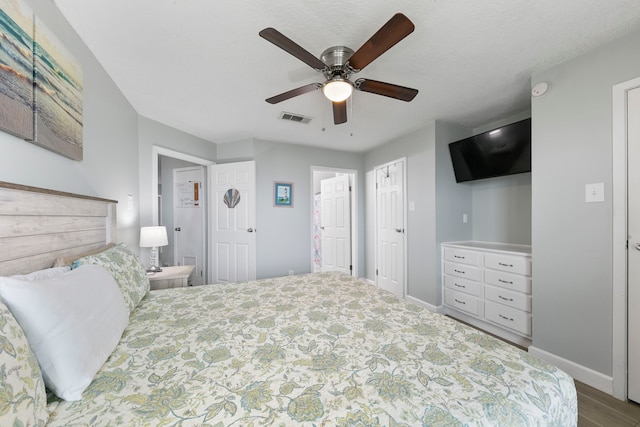 bedroom with ensuite bath, hardwood / wood-style floors, and ceiling fan