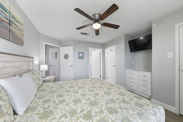 7600 Seawall Blvd Unit 115, Galveston, TX 77551 - bedroom with baseboards, a ceiling fan, and wood finished floors