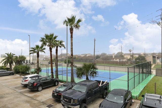 7600 Seawall Blvd Unit 115, Galveston, TX 77551 - uncovered parking lot with a tennis court