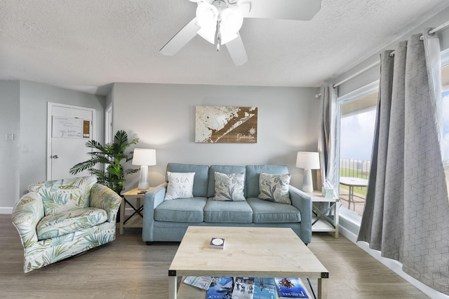 7600 Seawall Blvd Unit 115, Galveston, TX 77551 - living room featuring a textured ceiling, wood finished floors, and ceiling fan
