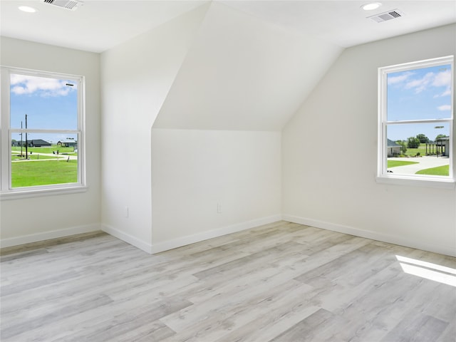 bonus room featuring vaulted ceiling and light wood-type flooring