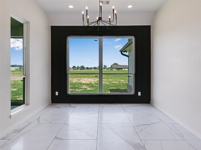 unfurnished dining area featuring a notable chandelier