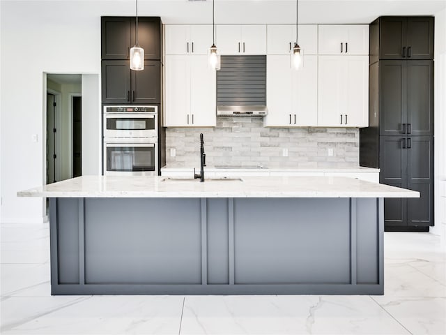 kitchen with white cabinetry, double oven, decorative light fixtures, and light stone counters