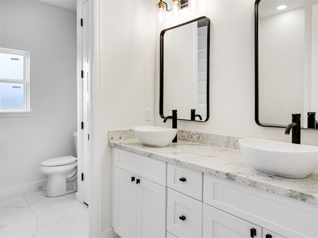 bathroom featuring toilet and vanity