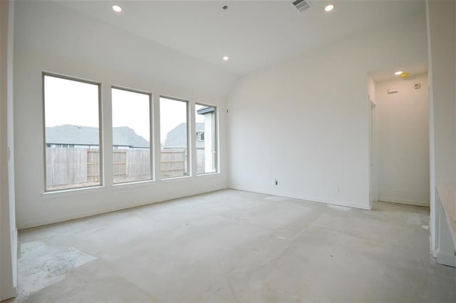 spare room featuring lofted ceiling and a mountain view