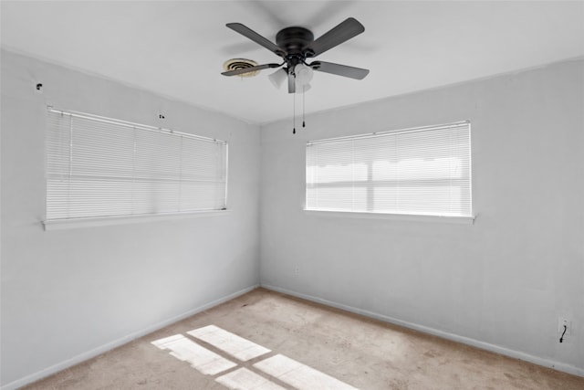 carpeted spare room with ceiling fan