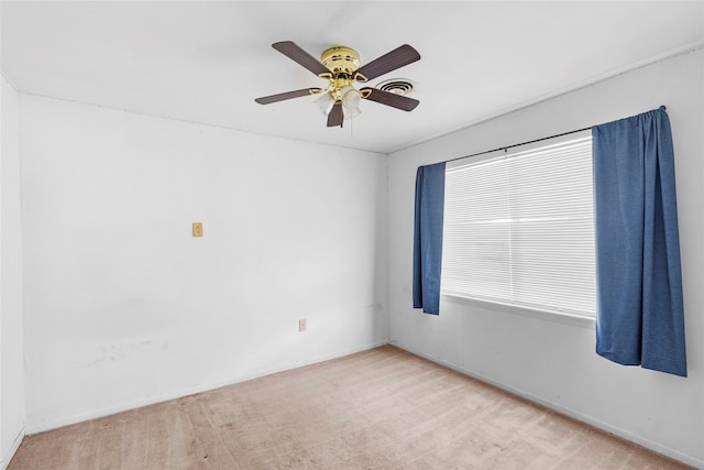 carpeted spare room with ceiling fan