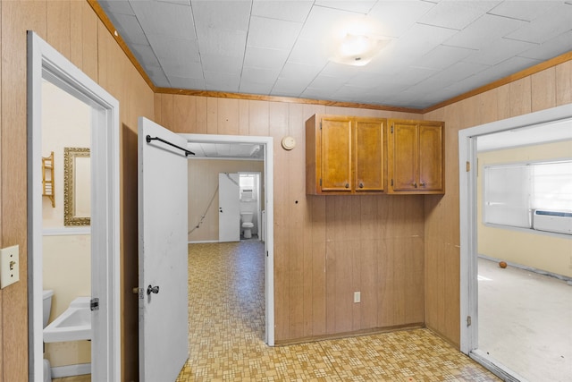 corridor featuring wooden walls