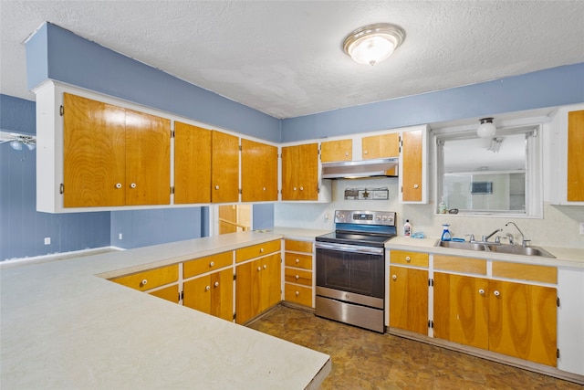 kitchen with a textured ceiling, stainless steel range with electric stovetop, and sink