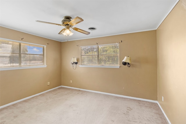 carpeted empty room with ceiling fan and ornamental molding