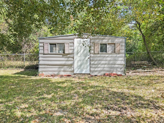 view of outdoor structure featuring a lawn