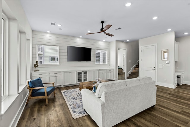 living room with dark hardwood / wood-style floors and ceiling fan