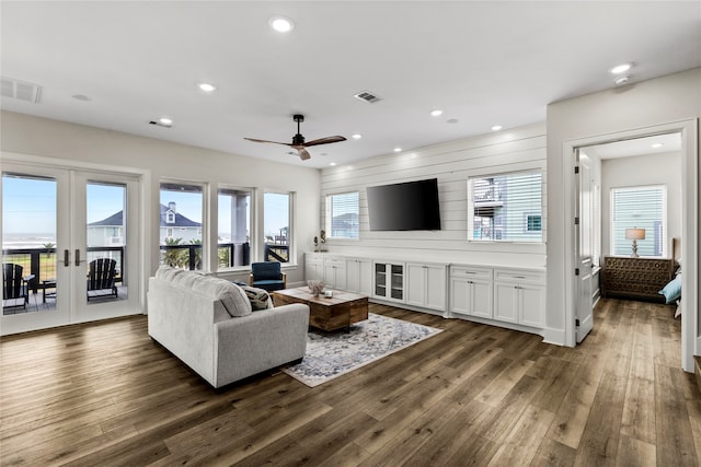 living room featuring french doors, dark hardwood / wood-style floors, and ceiling fan